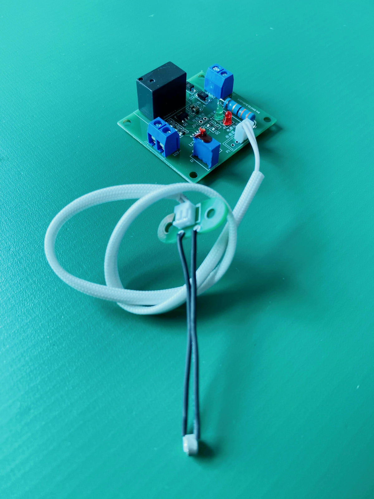 Complete 12V DC Duct Airflow Switch Assembly with Controller PCBA, Coiled White Cable, and External Thermal Airflow Sensor Probe