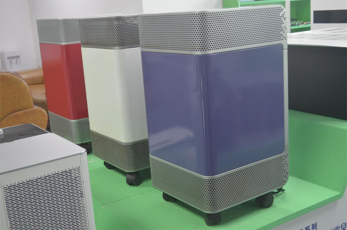 Factory production line and showroom display of KINYO-CHINA KY-APS-1000 commercial medical air purifiers demonstrating precision sheet metal fabrication, robust multi-color powder coating, and complete industrial clean air equipment manufacturing.
