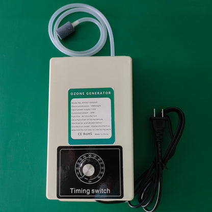 Overhead studio photograph of KINYO-CHINA KYOG110V02GT ozone generator module with 110V AC two-prong plug, showcasing the front countdown timer dial, green model identification label, and aeration accessory kit for domestic and commercial water ozonation.