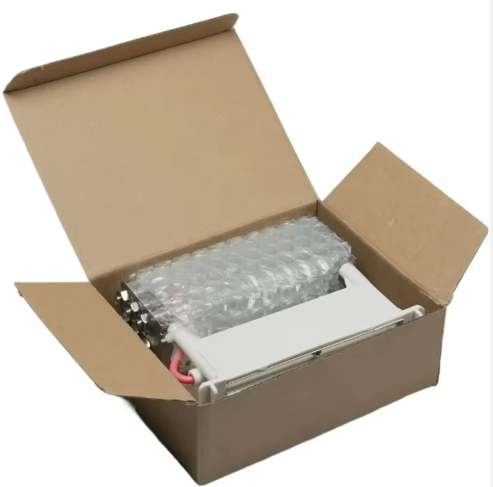Product packaging photograph of KINYO-CHINA ozone tube generator module securely cushioned inside protective bubble wrap within a sturdy corrugated cardboard shipping carton, ready for international B2B export shipment, OEM appliance manufacturing supply, and wholesale distribution.