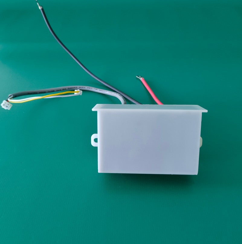    Side elevation profile photograph of the compact KYOG12V03 high-voltage power supply enclosure on a green surface, illustrating the streamlined rectangular housing design, dual chassis screw mounting ears, and neatly routed primary DC input and high-voltage output wiring leads.
   