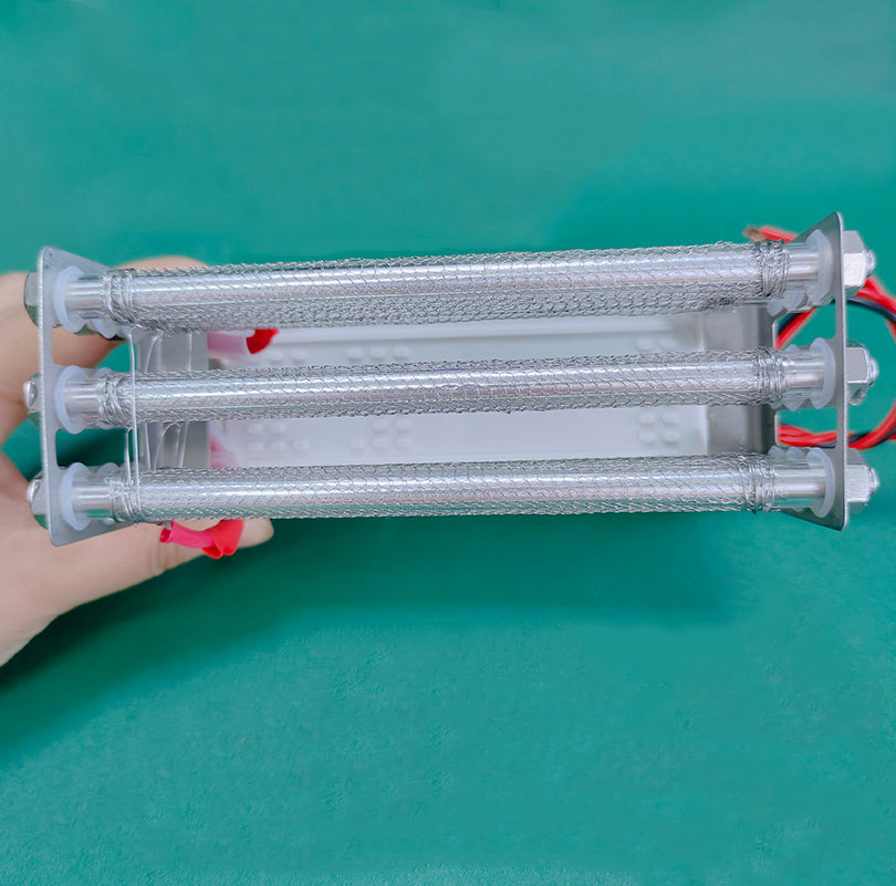 Top-down perspective studio shot of KINYO-CHINA KYOG220V27G 27g/h ozone generator held by hand demonstrating the compact 200mm tube length, stainless steel mesh outer sleeves, and robust structural assembly delivering 3.1kV to 3.5kV high-frequency pulse discharge at 16kHz for portable deodorization and commercial appliance integration.